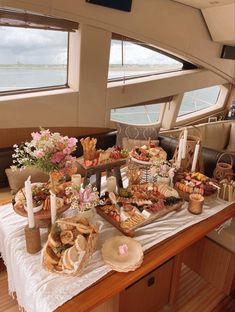 a table filled with food on top of a boat