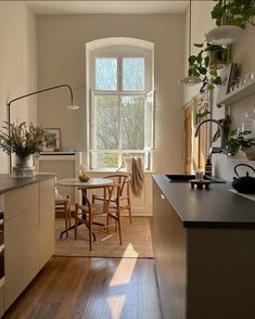 the kitchen is clean and ready to be used for dinner or lunchtime, while the sun shines through the window