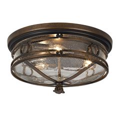 an old fashioned ceiling light fixture with glass shades and metal details on the rims