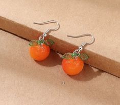 Bright and cute little orange tangerine drop earrings in orange and green. Orange Resin Dangle Earrings, Cute Nickel-free Orange Jewelry, Orange Round Earrings For Summer, Summer Orange Drop Earrings, Trendy Orange Drop Earrings, Trendy Orange Round Earrings, Elegant Orange Resin Jewelry, Orange Dangle Resin Earrings, Orange Earrings For Summer Gifting