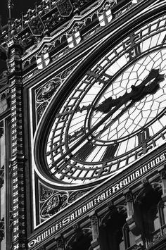 the big ben clock tower towering over the city of london, england in black and white