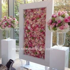 two vases filled with flowers sitting on top of a table