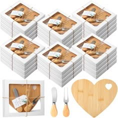 a set of six wooden utensils in boxes with tags on them and a heart - shaped cutting board