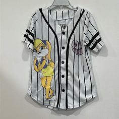 For Sale Is A Brand New Without Tags Looney Toons Lola Bunny Kids Baseball Jersey In Size 7/8. This White & Black Pinstriped Jersey Features Space Jam's Lola Bunny On Both The Front And Back. All The Lettering On Both Sides Are Adorned With Pink Rhinestone Bling. Comes From A Smoke Free And Pet Free Home. White Tops With Character Print For Spring, White Character Print Top For Spring, White Cartoon Print Shirt For Spring, White Hip Hop Tops With Character Print, White Cotton Baseball Jersey For Summer, White Cartoon Print Top For Playwear, White Character Print T-shirt For Playwear, White Character Print T-shirt For Play, White Graphic Print T-shirt For Playwear