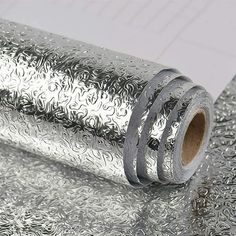 a roll of silver foil sitting on top of a table