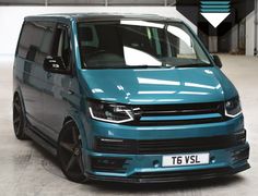 a blue van parked in a garage with the words vw transport on it's side