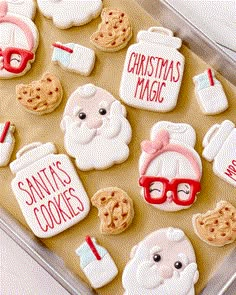 decorated cookies in the shape of santa's cookies and other holiday treats on a cookie sheet