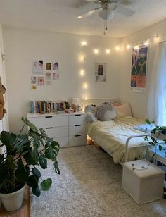 a bedroom with white walls and lights on the ceiling