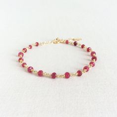 "This is a Ruby bracelet made of 3mm Ruby beads and sterling silver gold plated wire. The total length for this July Birthstone bracelet is 7.5\" including 2\" extension chain. This Ruby bracelet is simple and elegant. The dainty gold bracelet is great to layer with other tiny gold bracelet. Measurement: 3mm Ruby 6\" - 7.5\" long Gift Wrap: Please add this item to your shopping cart if you would like it to be gift wrapped. https://www.etsy.com/listing/217575192/gift-wrap-jewelry-gift-wrap-holida Elegant Ruby Gemstone Beads Bracelets, Adjustable Ruby Bracelets Gift, Elegant Ruby Beaded Bracelets With Gemstones, Adjustable Ruby Gemstone Bracelet, Elegant Ruby Gemstone Beaded Bracelets, Adjustable Elegant Ruby Bracelet, Elegant Handmade Red Charm Bracelet, Elegant Red Handmade Charm Bracelet, Dainty Yellow Gold Bracelets With Gemstone Beads