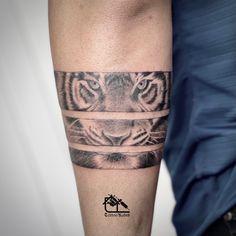 a man with a tiger tattoo on his arm