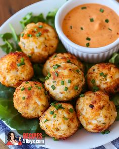 crab cakes on a plate with dipping sauce