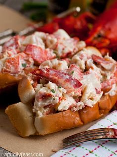 lobster salad in bread on a plate with a fork