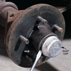 the brake assembly on a car with an arrow pointing to it's center hub