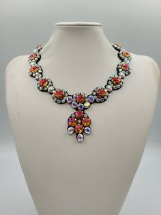 Each piece of our statement necklaces is handmade and one of a kind made in Italy. Our creations is made of high quality materials such as crystals and rhinestones. Each embroidered material is carefully hand sewn. Very glamorous and stylish. Perfect gift to someone you like. Materials Strass stones in Crystal Rainbow and Astral Pink color in different shape and dimension.  Black eco leather backing. Aluminium color hook closure. Measurements Weight approximate 150 grams. Circumference approximate 59 cm - 23,22 in Feel free to contact us if you have any question. Thank you so much for looking at our shop and our articles each of them, single piece. Crystal Jeweled Necklaces For Celebration, Handmade Party Pendant Crystal Necklace, Handmade Multicolor Crystal Necklace, Handmade Costume Jewelry Crystal Necklace For Party, Jeweled Crystal Costume Necklaces For Gifts, Jeweled Crystal Costume Jewelry Necklace For Gift, Jeweled Crystal Costume Jewelry Necklaces For Gifts, Unique Rhinestone Necklace For Gifts, Unique Rhinestone Necklaces For Gifts