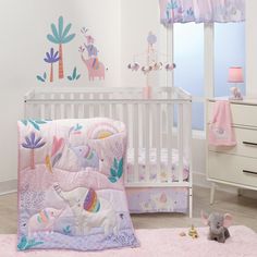 a baby's room with pink and white decor