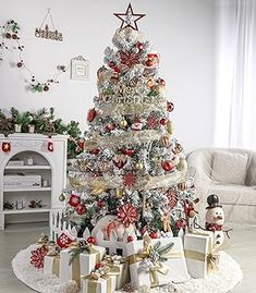 a decorated christmas tree in a living room with presents on the floor and decorations around it