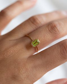 Prong octagon peridot ring  Eye catching yet, dainty simple design. Perfect way to cherish a special august birthday or to simply wear it for its beautiful light green color Material: 14k gold Gemstone: 6 x 4mm octagon peridot faceted gemstone Band width: 1mm Light Green Gemstone Ring, Lime Green Gemstone Birthstone Ring As Gift, Lime Green Gemstone Birthstone Ring For Gift, Lime Green Birthstone Ring As A Gift, Minimalist Emerald Cut May Birthstone Ring, Minimalist May Birthstone Ring With Emerald Cut, Emerald Cut Peridot Ring For May Birthstone, Yellow Gold Peridot Jewelry With Emerald Cut, Emerald Cut Peridot Gemstone Jewelry