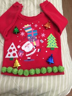 a red sweater with christmas decorations on it