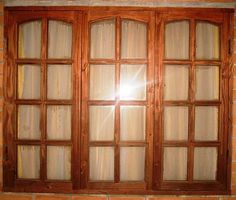 the sun shines through an open window in a brick wall with glass panes