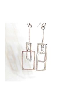 "These geometric  rectangular earrings are interconnected perpendicularly to one another, and look great from every angle!  Handcrafted from sterling silver and measure approximately 2\" in length. Made to order can be customized! With sterling silver ear hook. ~ All jewelry is boxed and ready for gift giving. DETAILS: ~ Components are sterling silver  ~ Earrings measure approximately 2\" in length  ~ Ships at no extra charge. ~ Gift wrapping option available at checkout. Include a special message in the card. ~ Handmade in Austin, Texas ❤️YOU MAY ALSO LIKE THESE ITEMS❤️ https://www.etsy.com/listing/55801648/square-dangle-earrings?ga_search_query=rectangle&ref=shop_items_search_4&frs=1 https://www.etsy.com/listing/270702625/silver-sliver-over-darkened-copper?ga_search_query=rectangle&ref=s Modern Silver Rectangular Earrings, Minimalist Silver Rectangular Earrings, Modern Silver Earrings With Rectangular Pendant, Modern Silver Rectangular Pendant Earrings, Modern Oblong Sterling Silver Earrings, Modern Sterling Silver Oblong Earrings, Sterling Silver Rectangular Everyday Earrings, Everyday Sterling Silver Rectangular Earrings, Modern Handmade Oblong Earrings