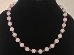 10 mm rose quartz beads with 6mm amethysts make this necklace a lovely alternative to traditional pearls for daytime and evening wear. Silvertone toggle clasp makes it easy to wear this elegant, understated piece. The simplicity of this necklace makes it appropriate for both women and girls. Elegant Lavender Crystal Necklace With Round Beads, Elegant Round Crystal Necklaces With 8mm Beads, Elegant Rose Quartz Round Beads Crystal Necklace, Elegant Rose Quartz Crystal Necklace With Round Beads, Elegant Rose Quartz Round Bead Necklace, Elegant Rose Quartz Beaded Necklaces, Rose Quartz Beads, Quartz Beads, Amethyst Necklace