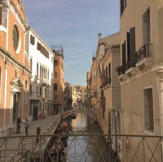 a narrow canal runs between two buildings in the city