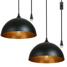 two black and gold pendant lights hanging from the ceiling with one light on each side