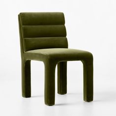 a green chair sitting on top of a white floor