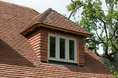 a red brick roof with a white window