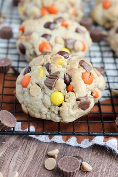 chocolate chip cookies with candy corn and m & m's on a cooling rack