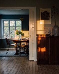 a dining room table and chairs in front of a window