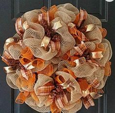 an orange and tan burlock wreath on a door