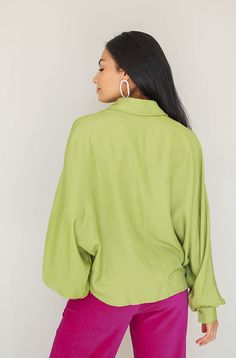 Product Fit + Details: Long Sleeves Dollman puff sleeves Lime Green Functioning buttons Shirt collar Boxy, oversized fit Soft, silky material Not sheer Also available in Cocoa Brown Model is 5’6” wearing a size S Size Bust Length S 48" 23" M 50" 24" L 52" 25" Outfit Details: Catalog Magenta Corduroy Pants Fabric + Care Instructions: 42% Polyester, 58% Rayon Hand wash in cold water Do not bleach Line dry Oversized Blouse With Blouson Sleeves For Fall, Green Blouson Sleeve Blouse For Work, Billowy Blouson Sleeve Tops For Workwear, Green Blouse With Blouson Sleeves For Work, Green Puff Sleeve Top For Fall, Fall Oversized Tops With Blouson Sleeves, Chic Bishop Sleeve Tops For Day Out, Billowy Tops With Gathered Sleeves For Work, Fall Collared Blouse With Blouson Sleeves