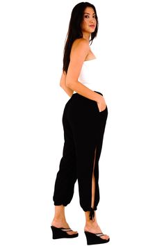 Shu-Shi women's summer harem pants feature a comfortable, lightweight style, that is both classy, yet sexy. The pants can be used as bikini cover-ups and can easily transition from daytime to nighttime by adding heels. Sexy side slits Side pockets 100% Rayon Machine wash cold water Trendy Full-length Harem Pants, Trendy Black Split Bottoms, Trendy Solid Color Harem Pants For Loungewear, Trendy Solid Harem Pants For Loungewear, Summer Pants With Elastic Side Panels, Chic Solid Color Bottoms With Split Design, Casual Pants With Side Slits, Casual Loungewear Bottoms With Side Slits, Casual Lounge Bottoms With Side Slits