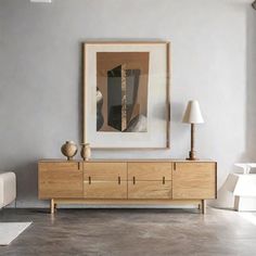 a living room with grey walls and white furniture in front of a painting on the wall