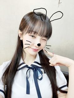 a girl with long hair and cat ears on her head is posing for the camera