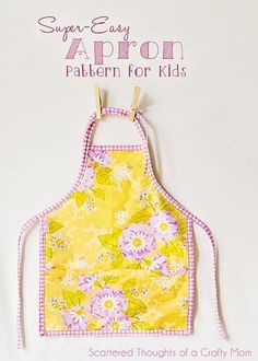 a yellow apron with pink and white flowers on it