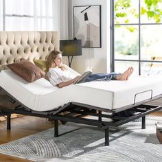 a woman laying on top of a bed in a room