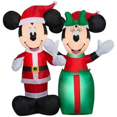 two inflatable mickey and minnie mouse characters standing next to each other on an inflatable ball