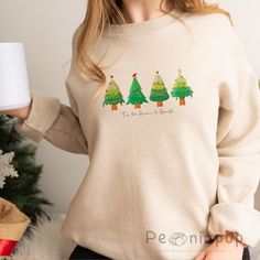 🎄Green Tree Christmas Crewneck Sweatshirt - Unisex Heavy Blend🎄 Celebrate the holiday season in comfort and style with our Green Tree Christmas Crewneck Sweatshirt. This unisex sweater is designed to keep you warm and cozy during the colder months while showcasing a festive green tree design that's perfect for Christmas! Made with a high-quality blend of 50% cotton and 50% polyester, it offers both softness and durability, making it a great choice for any casual holiday occasion. 🌟Key Features:🌟 🍀Festive & Cozy: The medium-heavy fabric blend (8.0 oz/yd²) ensures warmth and comfort while adding a touch of festive cheer to your wardrobe. 🍀Classic Fit: Designed with a crew neckline and a ribbed knit collar that retains its shape after every wash, providing a comfortable and stylish fit. Christmas Crewneck Sweatshirt, Holiday Sweaters, Christmas Crewneck, Green Tree, Unisex Sweater, Holiday Sweater, Tree Design, Tree Christmas, Green Trees