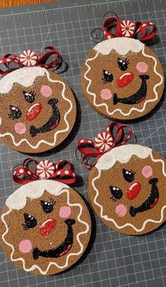 four gingerbread christmas ornaments on a cutting board