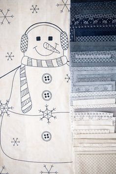 a snowman is depicted on a white background, surrounded by many different patterns and fabrics