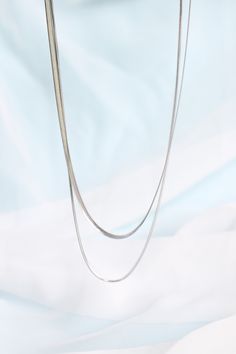 Okay we are obsessed! We LOVE the layered necklace look, and with this 2 in 1 necklace, you can achieve that style with ease. The herringbone style necklace chain is so classy and timeless, so you know you'll be wearing this for years and years. And since it's made to be such high quality (with solid stainless steel!) you know it will last you for years and years to come! Not only that- but because it is made with solid stainless steel, this necklace is also completely tarnish proof and complete Snake Chain Necklace With Double Chain For Layering, Silver Layered Necklace For Everyday, Silver Chain Necklaces For Layering, Trendy Everyday Layered Snake Chain Necklace, Minimalist Snake Chain Necklaces For Layering, Chic Necklaces With Silver Chain For Layering, Minimalist Layered Necklace With Clavicle Chain, Layered Double Strand Chain Necklace, Silver Everyday Layered Necklace