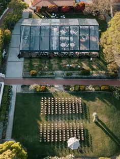 an aerial view of a wedding venue in the middle of a garden with rows of chairs