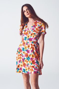 Introducing our Short Dress with Cinched Waist in Multicolor Floral Print, a boho-inspired piece that effortlessly combines style and comfort. This dress features a mini length, perfect for those looking to embrace a flirty and fun look. The vibrant floral print adds a touch of femininity and elegance to the dress, making it a standout piece in your wardrobe. The V-neck neckline enhances your neckline and creates a flattering frame for your upper body. Designed with puff sleeves, this dress adds