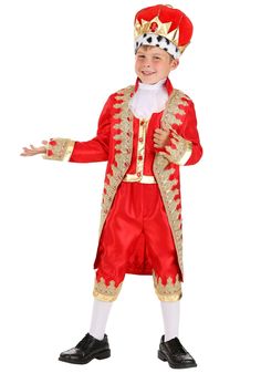 a little boy dressed in a red and gold costume with a crown on his head