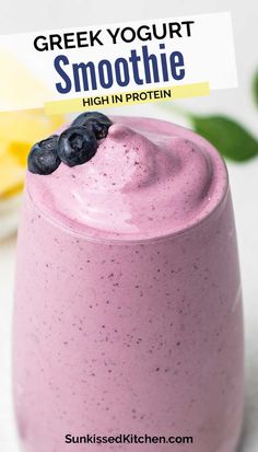 a smoothie in a glass with blueberries on top and the words, greek yogurt smoothie high in protein