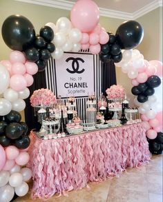 a chanel themed dessert table with black, white and pink balloons