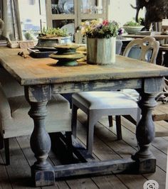 an old wooden table and chairs in a room