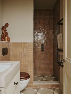 a bathroom with a toilet, sink and shower